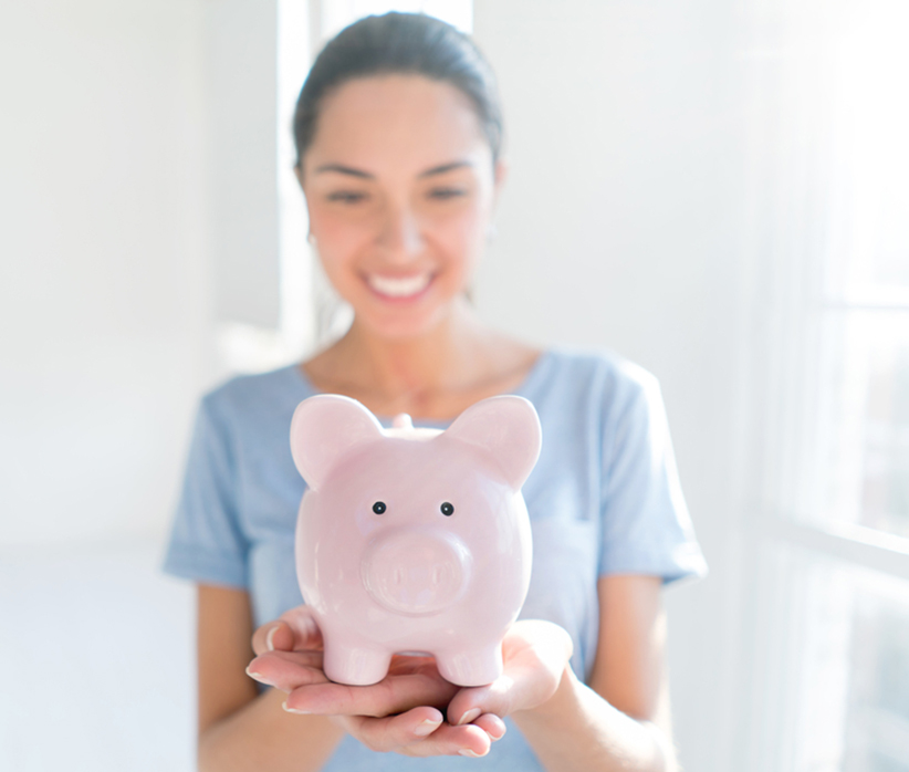 Young woman saving money in a piggybank